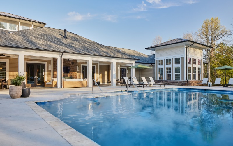 exterior building with pool and lounge chairs
