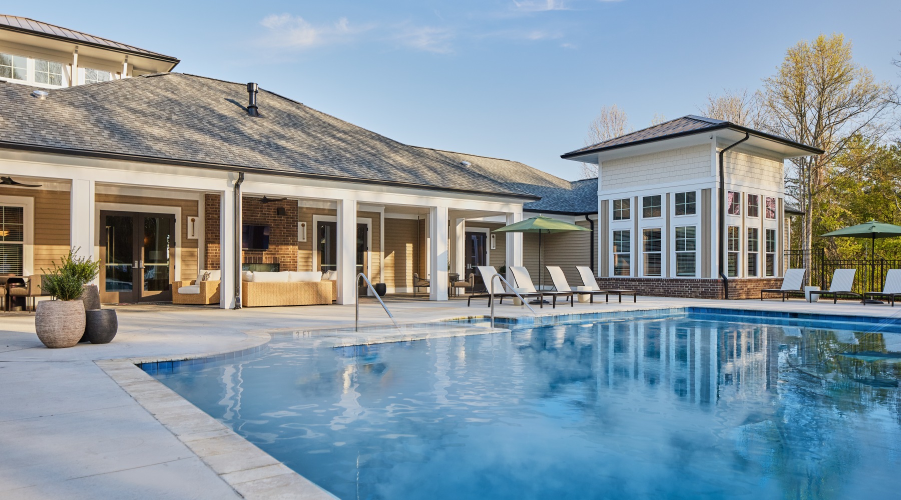 exterior building with pool and lounge chairs