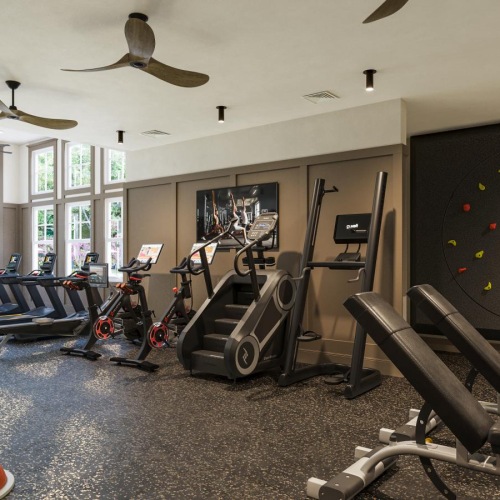 a room with exercise equipment and chairs