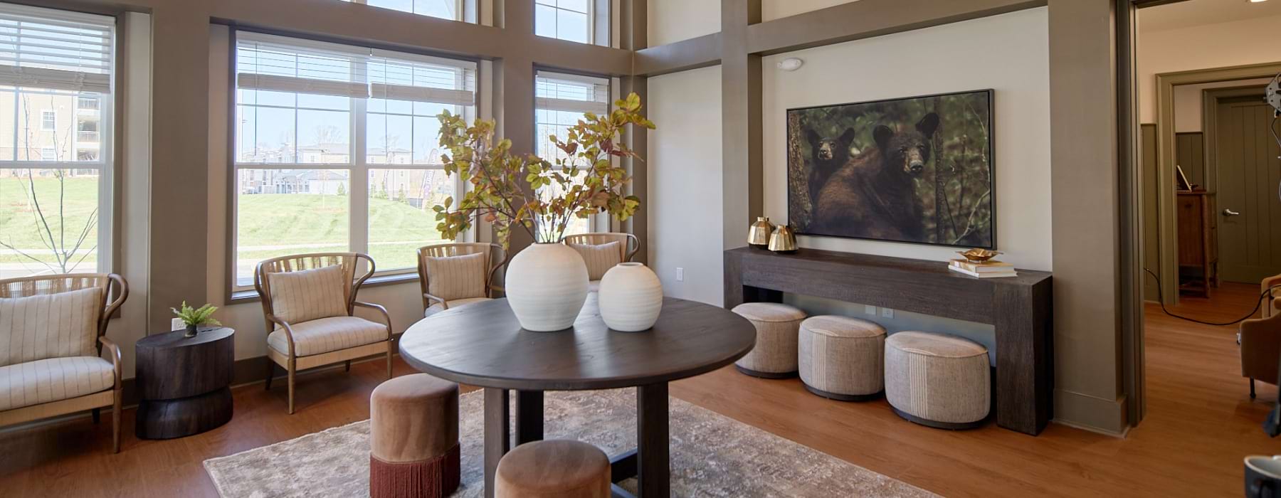 Entry tower space with tall ceilings, large windows, and modern seating, creating a bright and welcoming first impression